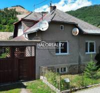 A family house in Tisovec, surrounded by nature, with satellite dishes on the roof.