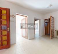 Entrance hall with a door and a radiator in a family house.