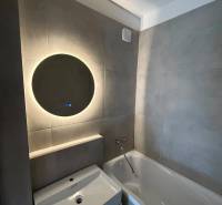 Bathroom with a bathtub and a sink in a 2-room apartment.
