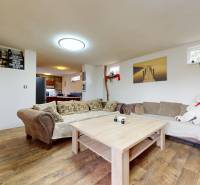 Living room in a family house with a comfortable sofa, wooden table, and decorations.