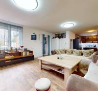 Living room in a family house with a wooden table, sofa, and bookshelf with books.