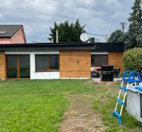 A family house on Poľná Street in Most pri Bratislave with a swimming pool and garden furniture.