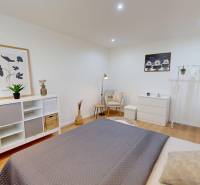 A room in a one-bedroom apartment with various storage solutions and decorations.