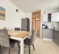 Dining area with kitchen in a 3-room apartment with a dining table.