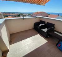 Two-room apartment in Novalja, terrace with sea view, two chairs, table.
