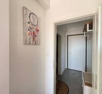 Entrance hallway in a 2-room apartment with a dreamcatcher picture on the wall.
