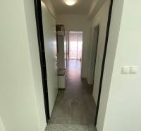 Entrance hallway of a 2-room apartment, with tiles and lighting.