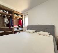 Bedroom with a double bed and a wardrobe in a 2-room apartment.
