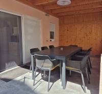 The 2-room apartment has a spacious terrace with a large dining table.