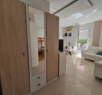 Interior of a 2-room apartment with a living room, wardrobes, and bright light.