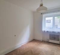 A room with a wooden floor, a window, and white walls in a 2-room apartment.