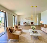 A spacious living room in a 3-room apartment with large windows and comfortable seating.