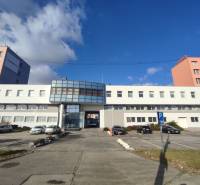 Offices on Vajnorská Street, Bratislava - Nové Mesto, with a parking area and cars.