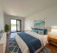 A bedroom in a 2-room apartment with a brisk touch of blue and white.