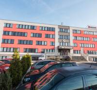 Office building on Pestovateľská Street in Bratislava - Ružinov with a parking lot and staircase.