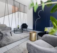 Offices with comfortable chairs, desks, and decor in neutral colors.