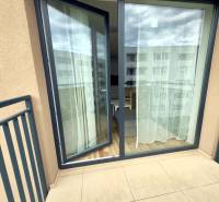 A balcony with sliding doors to a 2-room apartment, view of the street.