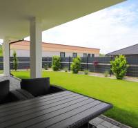 The terrace of a family house in Piešťany, with a view of the well-maintained garden and surrounding architecture.