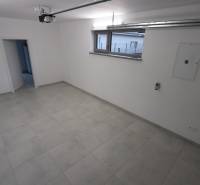 A spacious room with light tiles in a family house.
