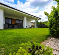 A family house in Piešťany with a green lawn, terrace, and landscaped garden.