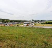 A family house in Piešťany surrounded by greenery, rural landscape, and neighboring houses.