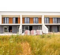 A family house in Piešťany with large windows, two floors, and an unfinished garden.