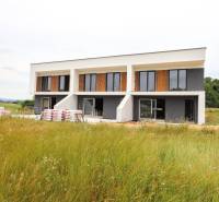 A family house in Piešťany with large windows in a natural environment.