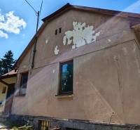 A family house on Dlhá Street in Vranov nad Topľou with damaged facade plaster.