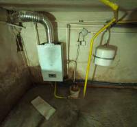 Gas boiler and piping in the basement of the family house.