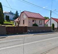 A family house on Dlhá Street in Vranov nad Topľou with a red roof and a wooden fence.