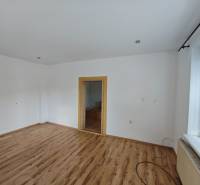 Interior of a family house with wooden flooring and two doors.