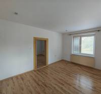 Transition room with wooden floor and window in a family house.