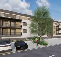 Construction of apartments in Kriváň with cars and people on the street near the apartment building.