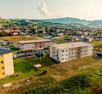 The construction of apartments in Kriváň surrounded by countryside and family houses.
