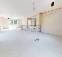 Spacious interior in a family house with large windows and preparation for electrical installations.