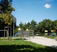 A playground surrounded by greenery and apartment buildings, Košice - Juh district.