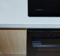 A kitchen unit in a 2-room apartment with a built-in cooktop and oven.