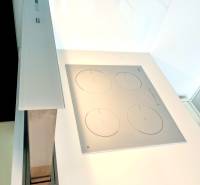 A kitchen countertop with a built-in cooktop and extractor in a 2-room apartment.