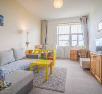 Living room with a light sofa and a yellow table in a 3-room apartment.