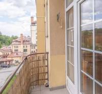 The balcony of a 3-room apartment in the High Tatras with a view of historic buildings.