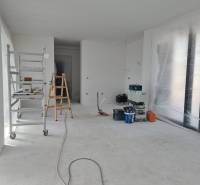 Interior renovation in a villa with a ladder, tools, and foil on the floor.