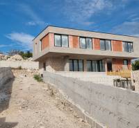 An unfinished villa in Vodice with a concrete terrace and modern windows.