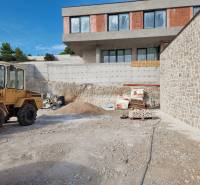 A construction site with a villa under construction in the city of Vodice, visible construction machinery and materials.