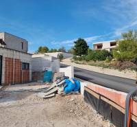 Building area at the villa in Vodice with a road and surrounding greenery.