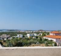 View from the Villa in Vodice of the coast with houses and greenery.