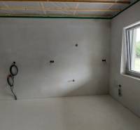 Interior renovations in a family house show an empty room with a window.