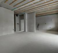 Interior of a family house with bare walls, preparation for installations, and large windows.