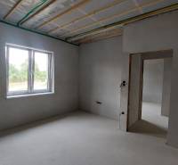 Interior of a family house with plastered walls, a window with a view.