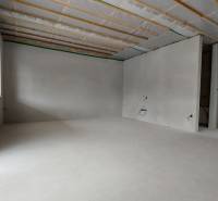 Corner room in a family house, bright walls, plasterboard ceiling, ready for modifications.