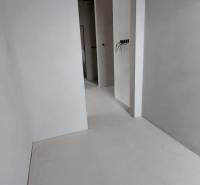 White wall and door opening in a family house with basic electrical installation.